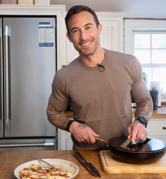 Michael Chernow cooking in his kitchen with Caraway cookware
