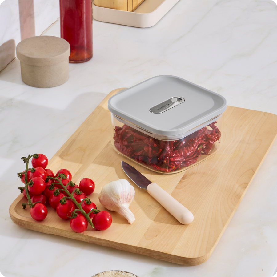 Glass container with food on cutting board