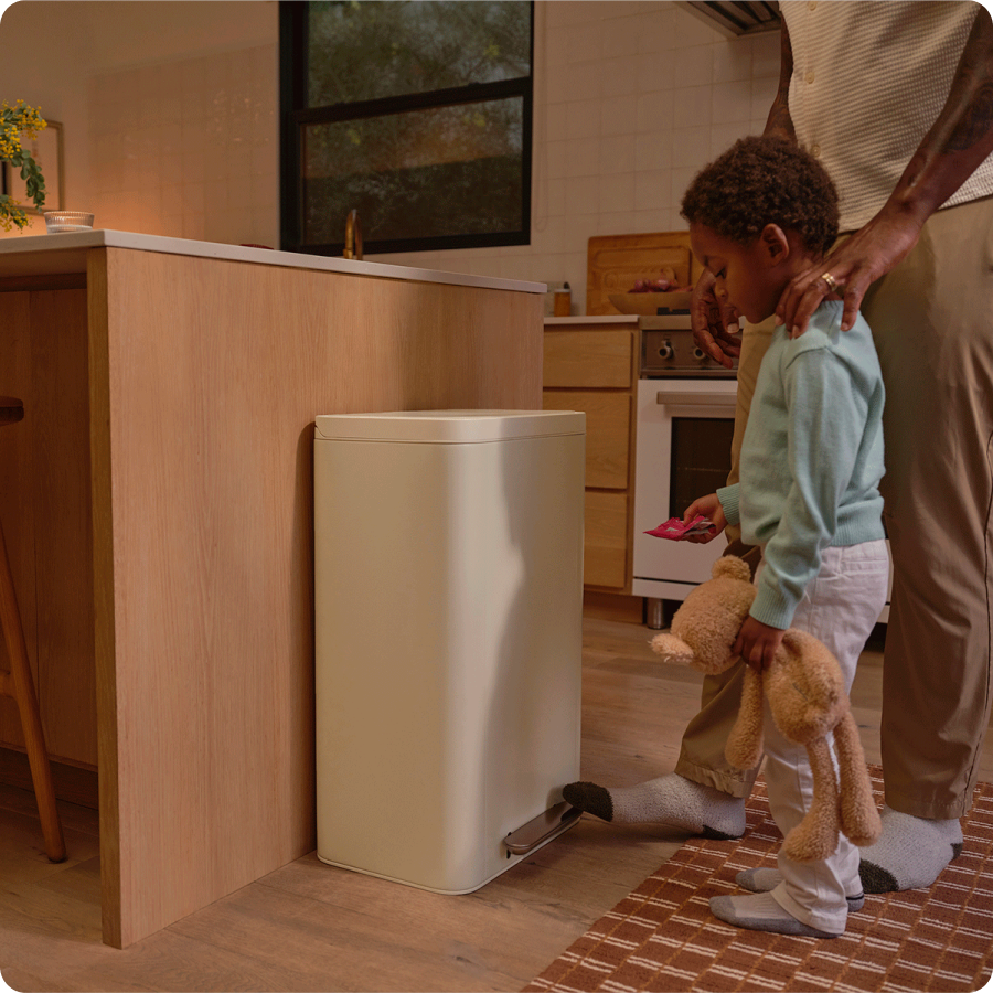 Trash can with step pedal being used hands-free